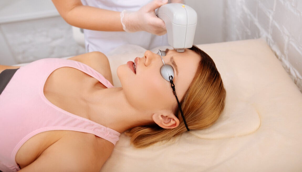 Blonde woman having broadband laser treatment