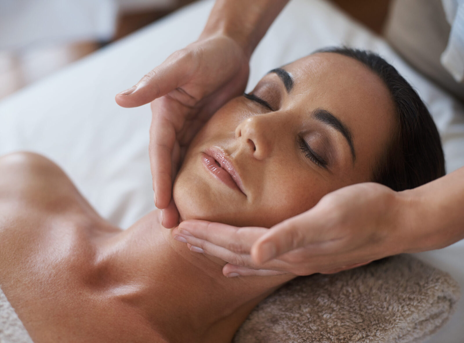 A women receiving a medical facial from a dermatologist.